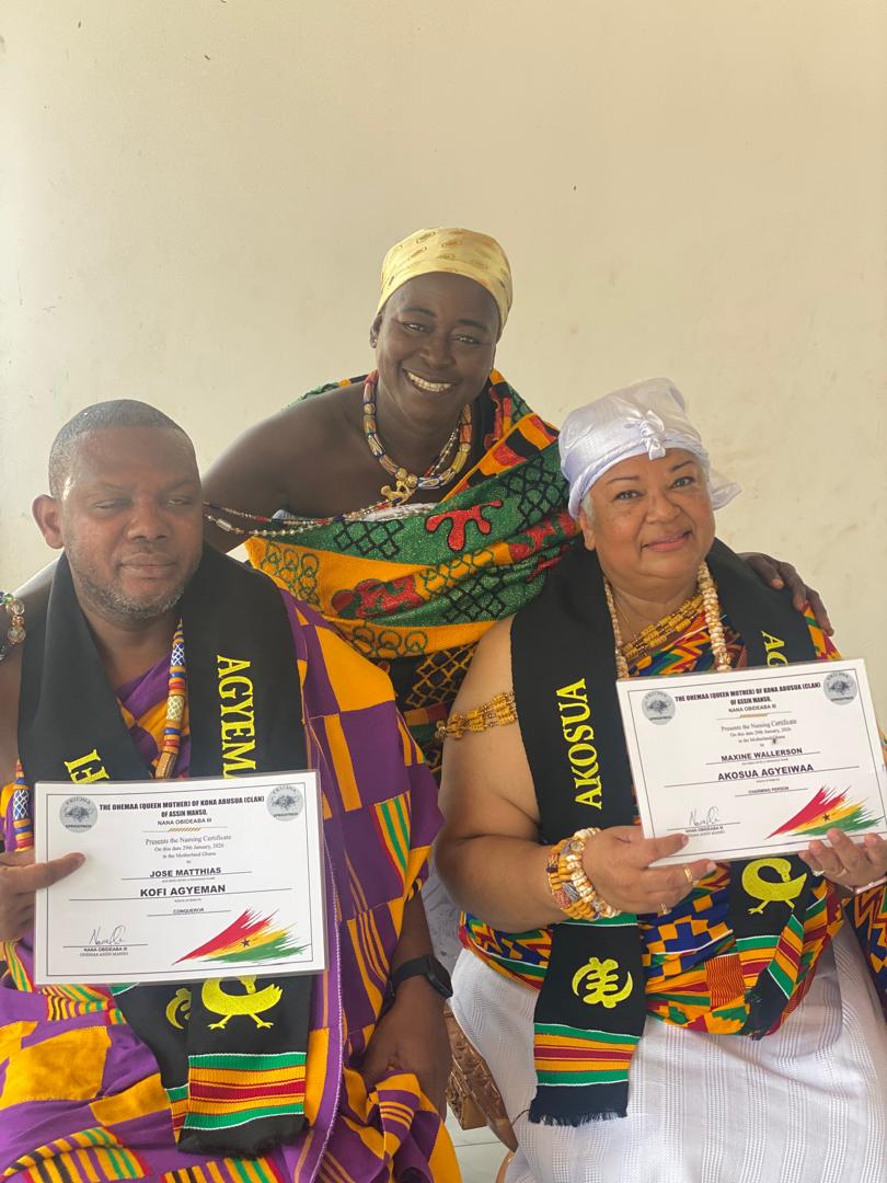 Guests holding their Ghanaian naming ceremony certificates alongside their host