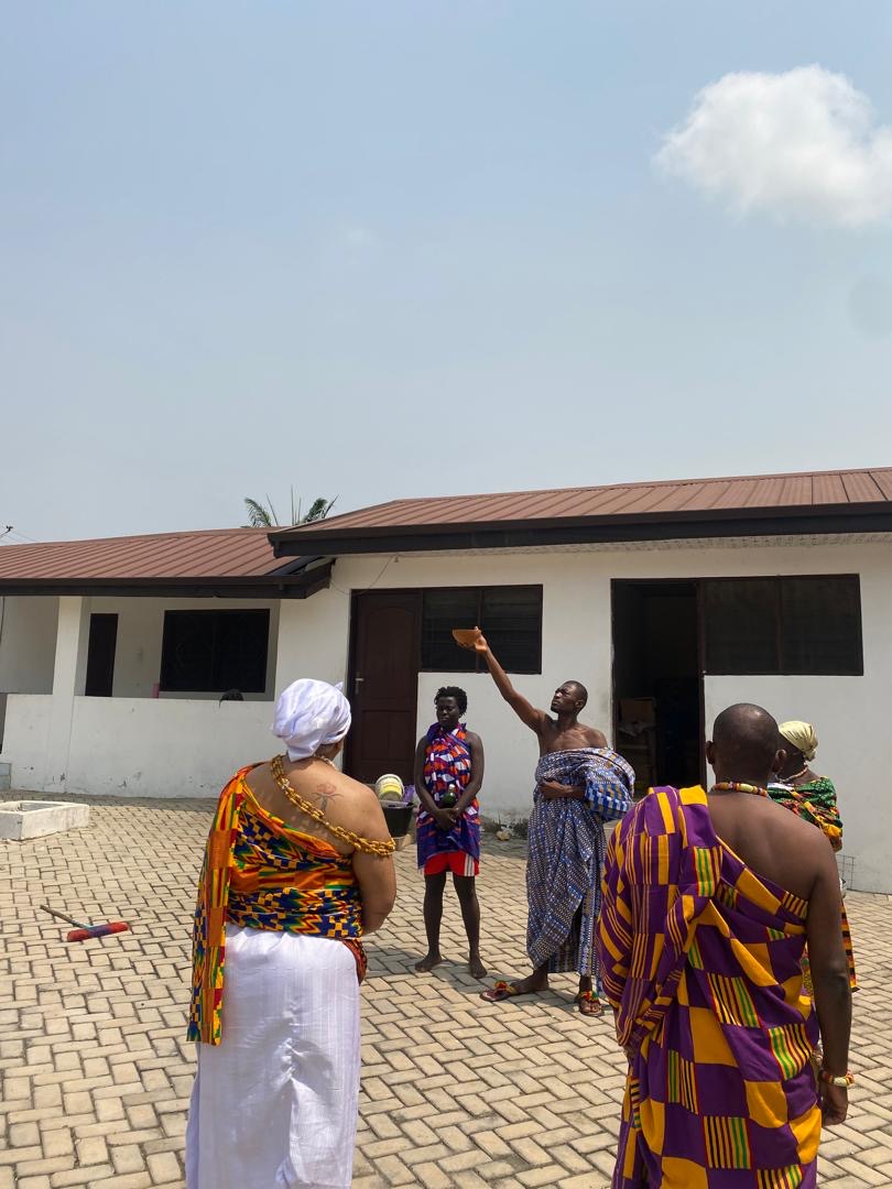 Guests and hosts gathered outdoors for a Ghanaian naming ceremony