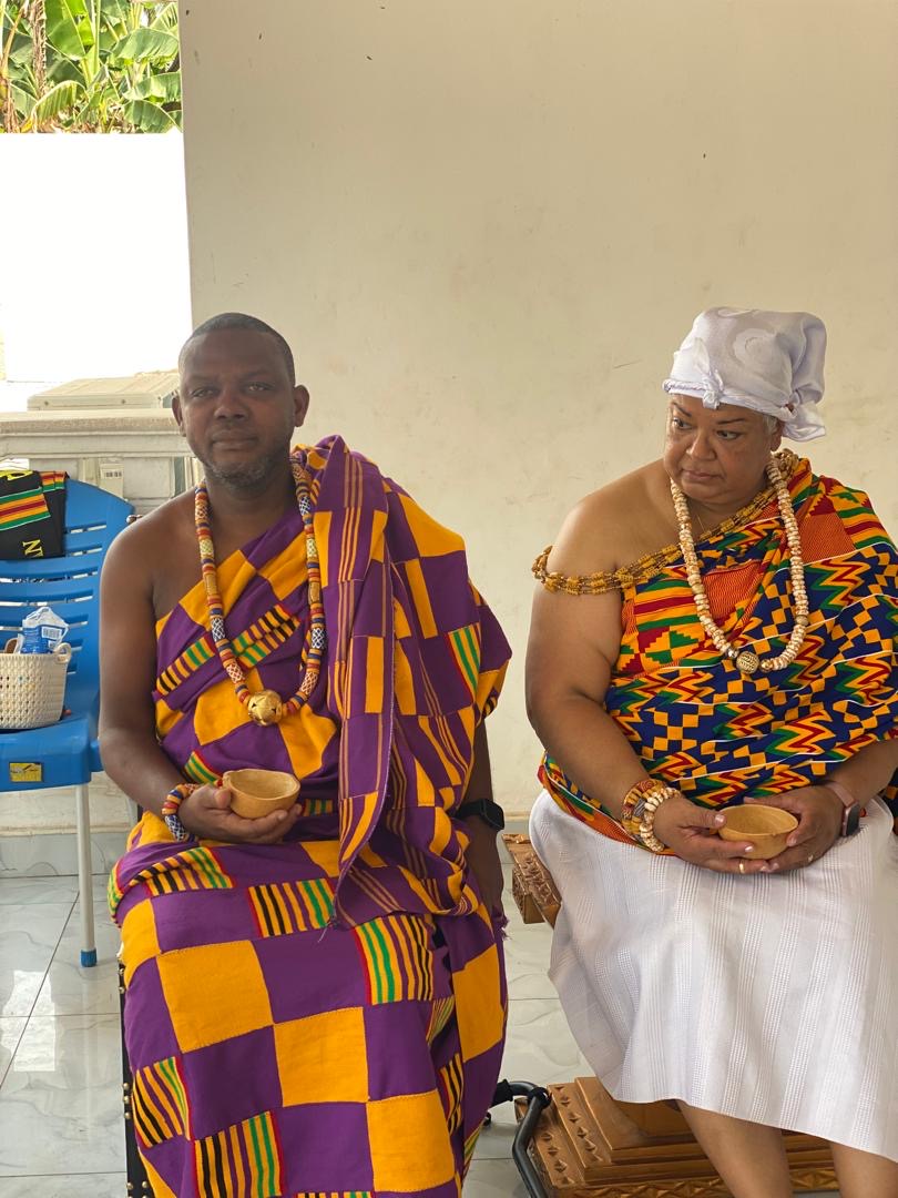 Naming ceremony guests wearing colorful traditional cloth and beads